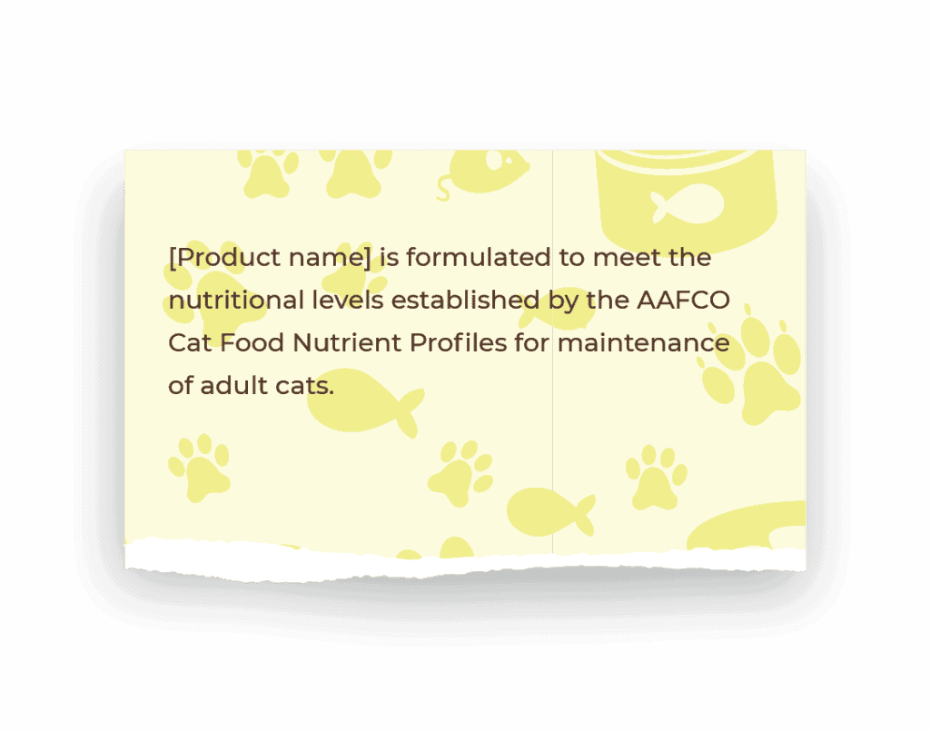 A yellow piece of paper with a background pattern of fish and pawprints has a torn bottom edge. The paper scrap reads: [Product name] is formulated to meet the nutritional levels established by the AAFCO Cat Food Nutrient Profiles for maintenance of adult cats. 